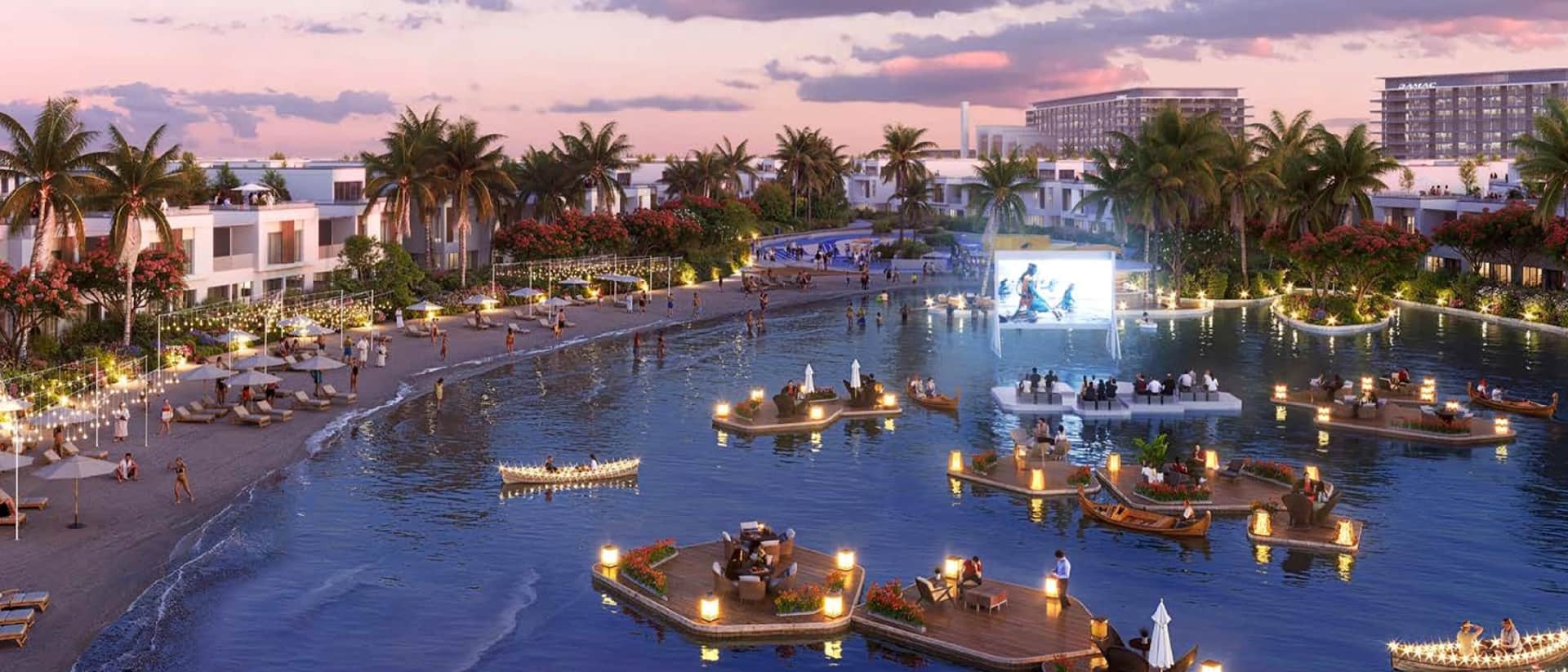 Evening view of a vibrant waterfront community with dining and entertainment