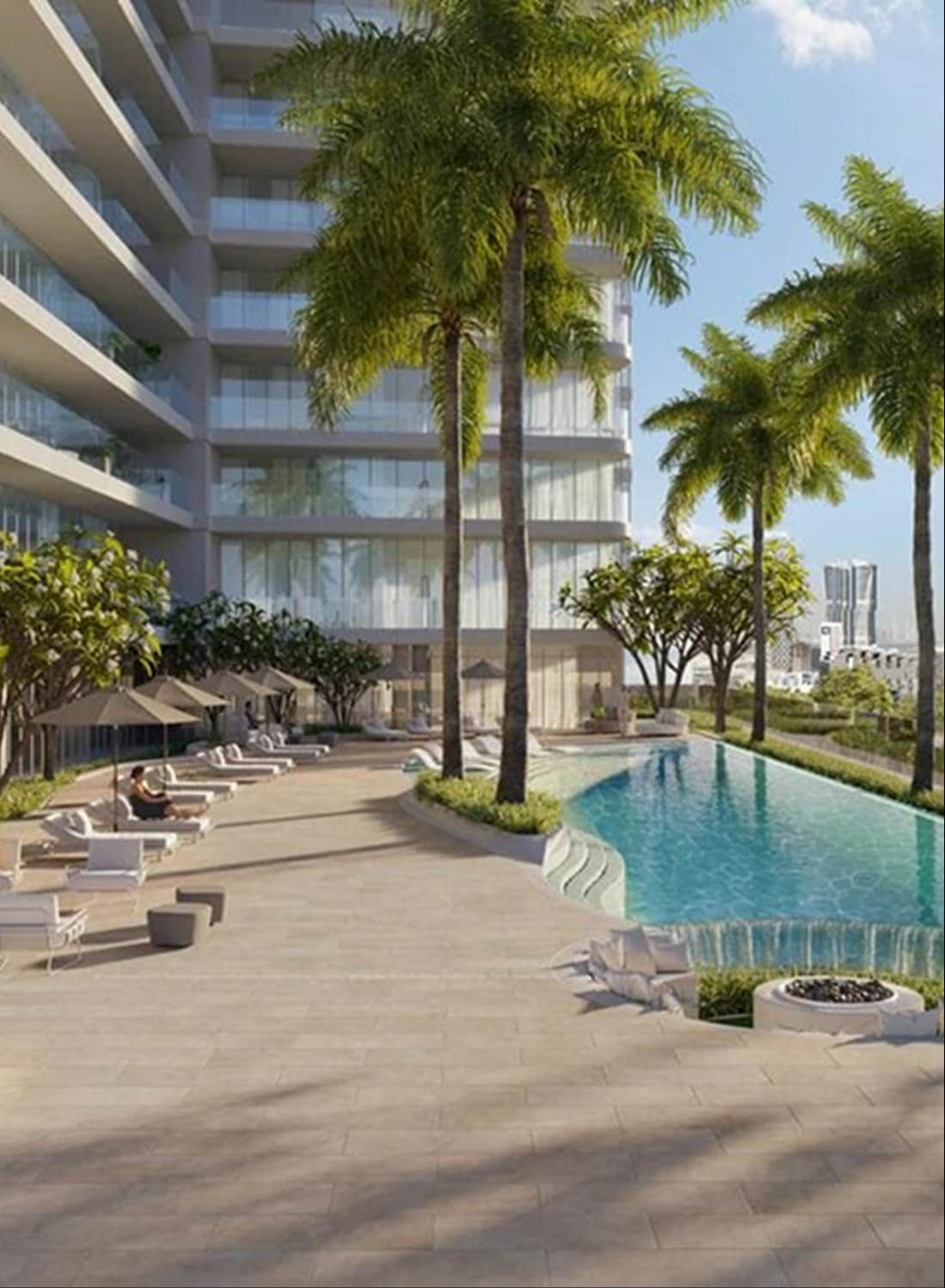 Poolside view with palm trees and modern buildings in the backdrop