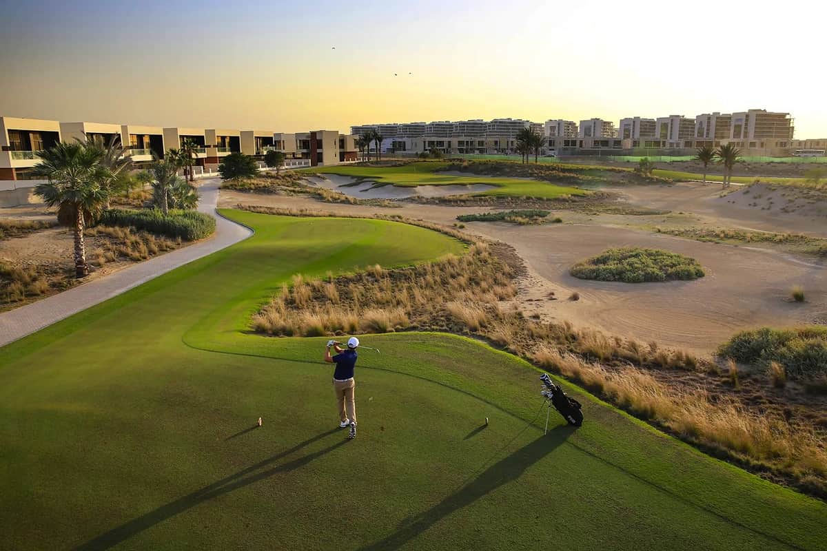 Golf course with villas and a golfer in the distance