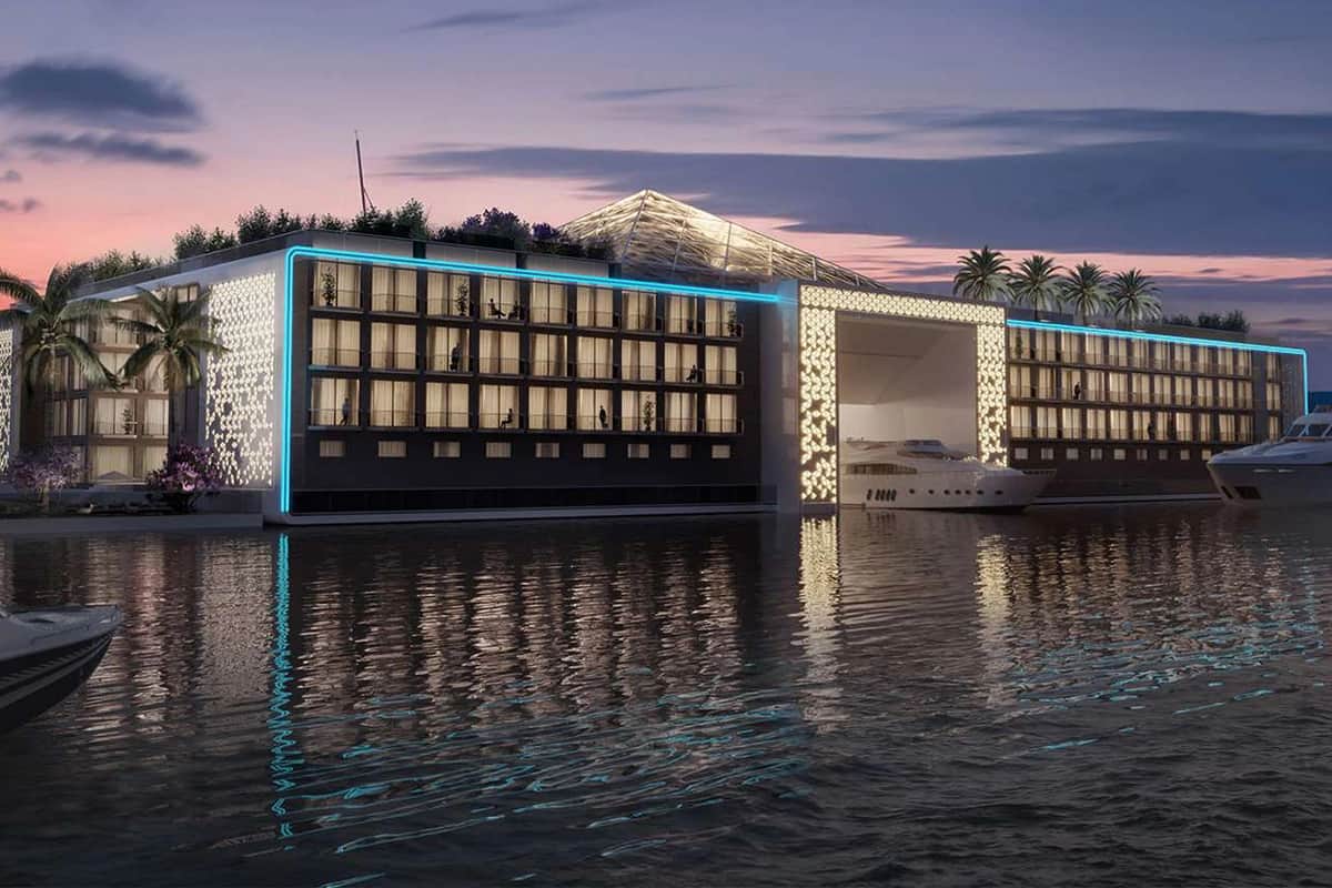 Modern waterfront property with boats and yachts at sunset