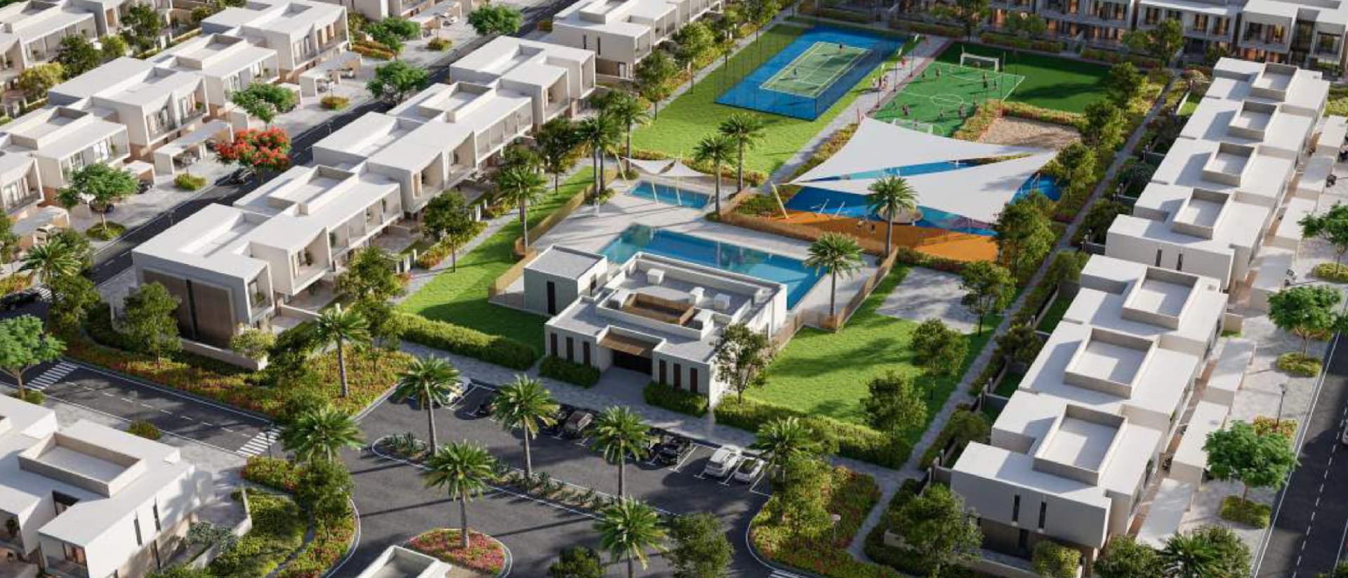 Aerial view of a community with modern townhouses, swimming pools, and sports courts