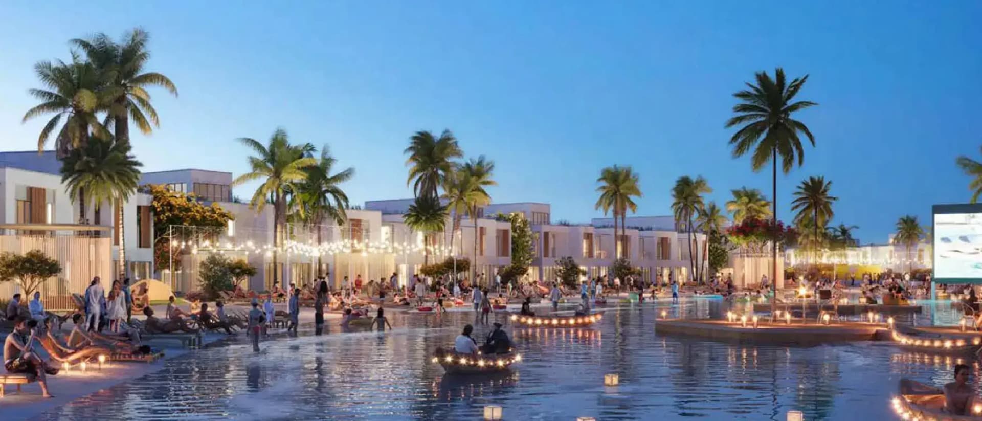 Waterfront development at dusk with palm trees