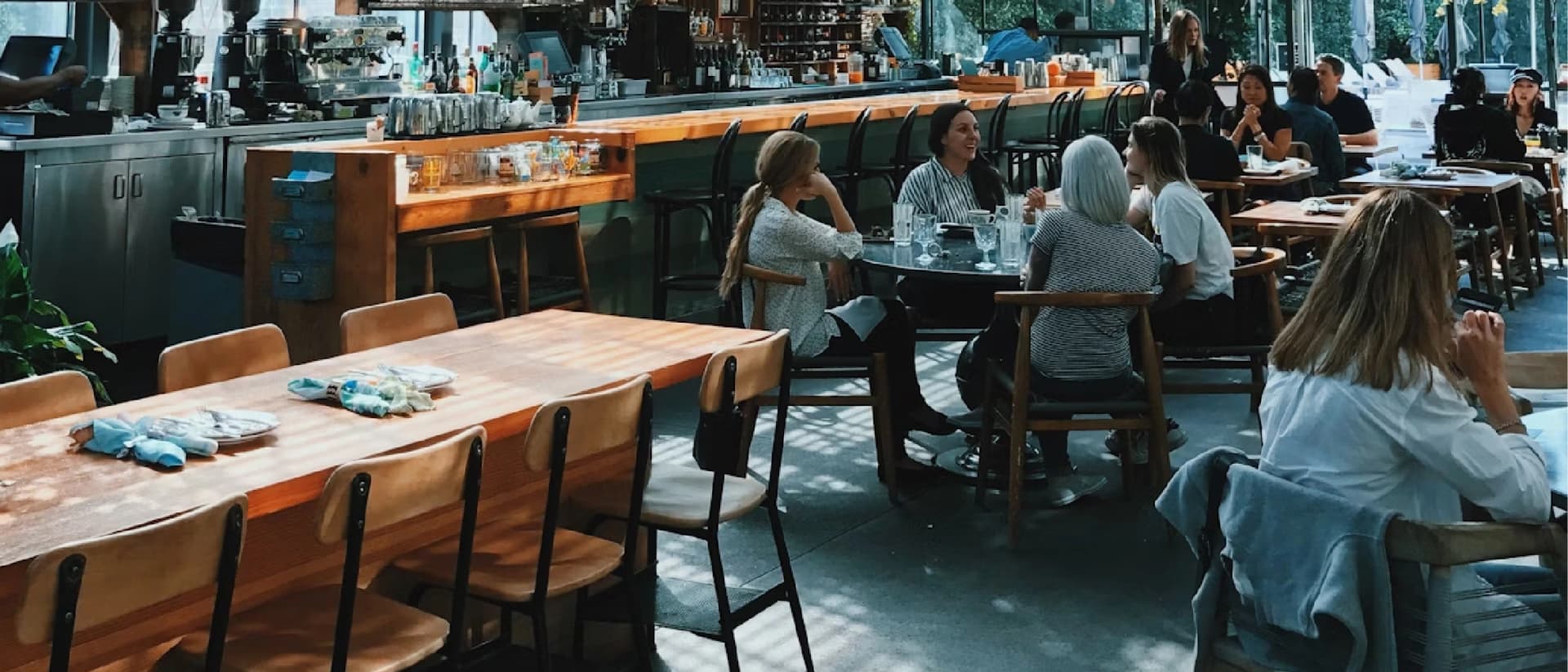 A cozy café with people chatting and enjoying drinks