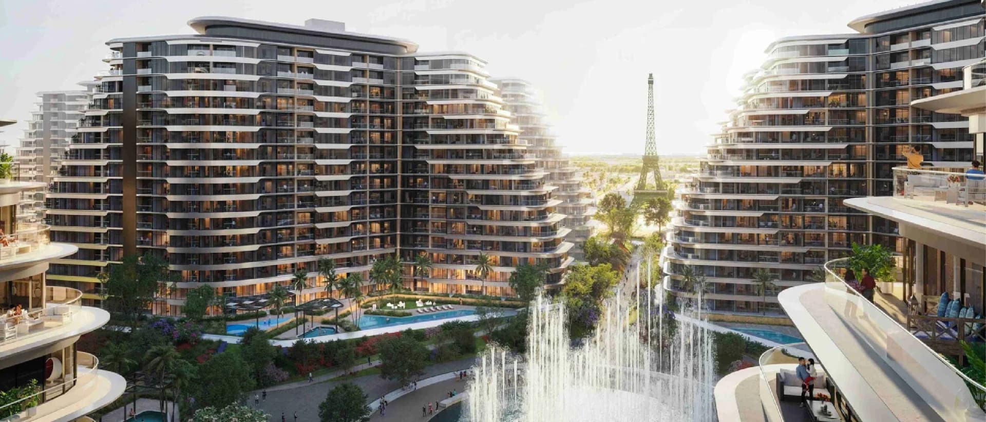 An urban complex with curved apartment buildings, a pool, and fountains