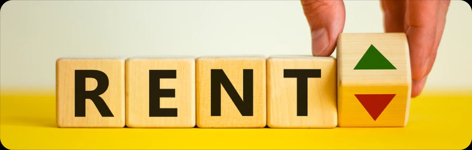 Wooden blocks spelling "RENT" with an arrow pointing up
