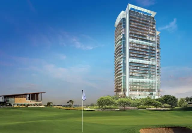 Modern high-rise hotel beside a green golf fairway