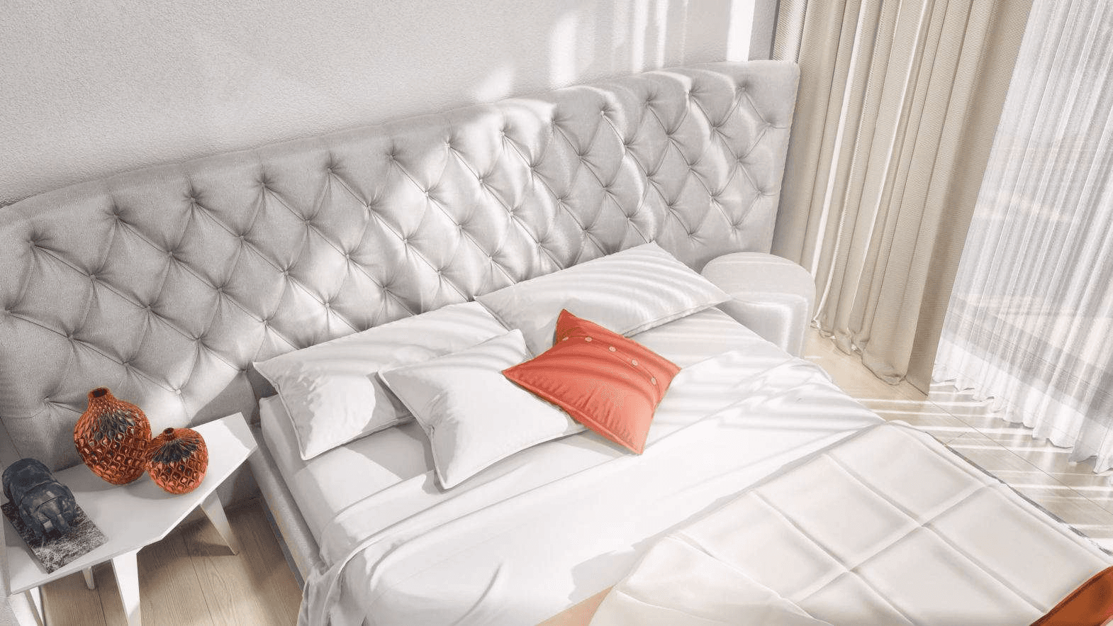 Bright bedroom with a tufted headboard and orange pillow
