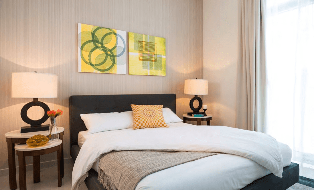 Cozy bedroom with yellow and green artwork