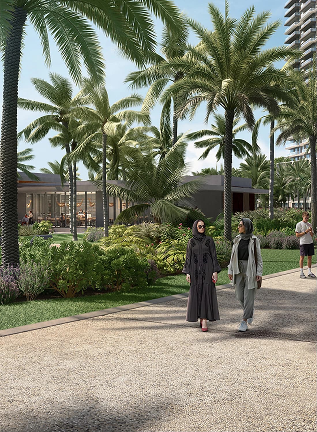 Two women walk along a park path with palm trees