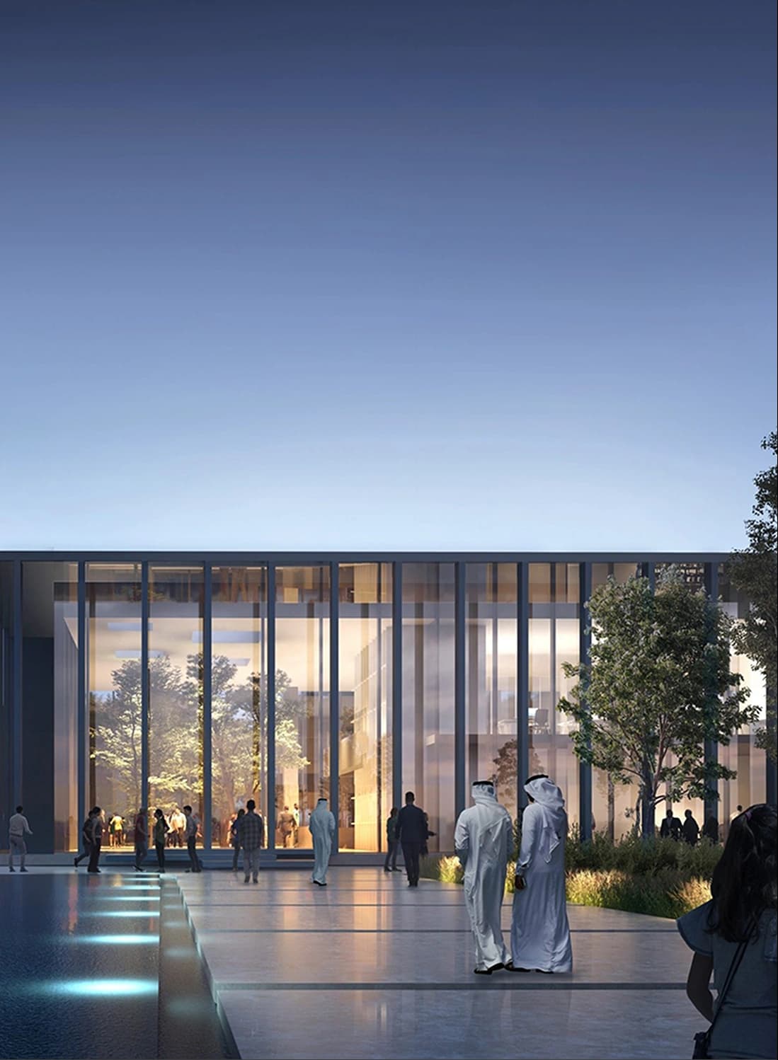 People walking by a sleek building with large windows at dusk