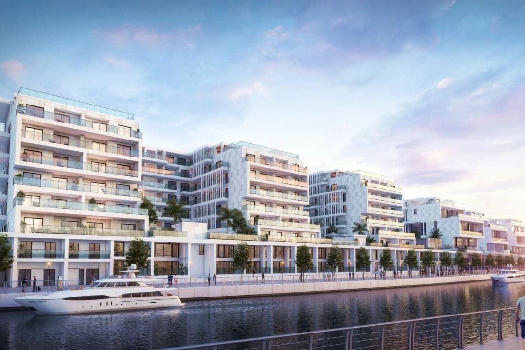 Luxury waterfront residential buildings with yachts and palm trees