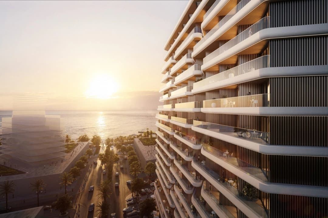 Sunset view of a sleek oceanfront building with modern design