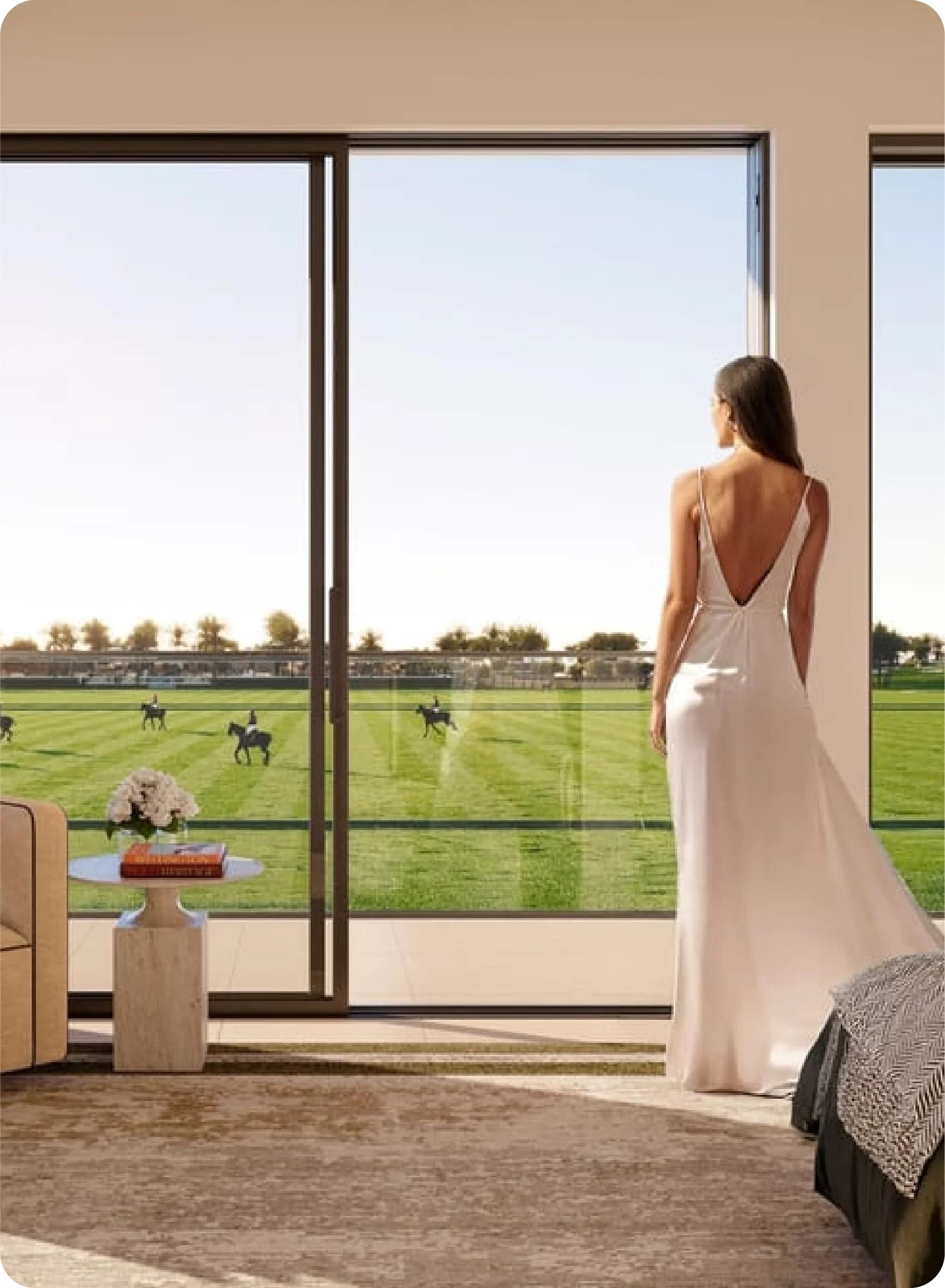 Infinity pool overlooks a polo field with riders