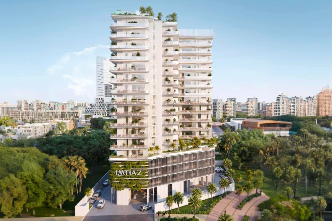 Contemporary residential tower with greenery and city backdrop