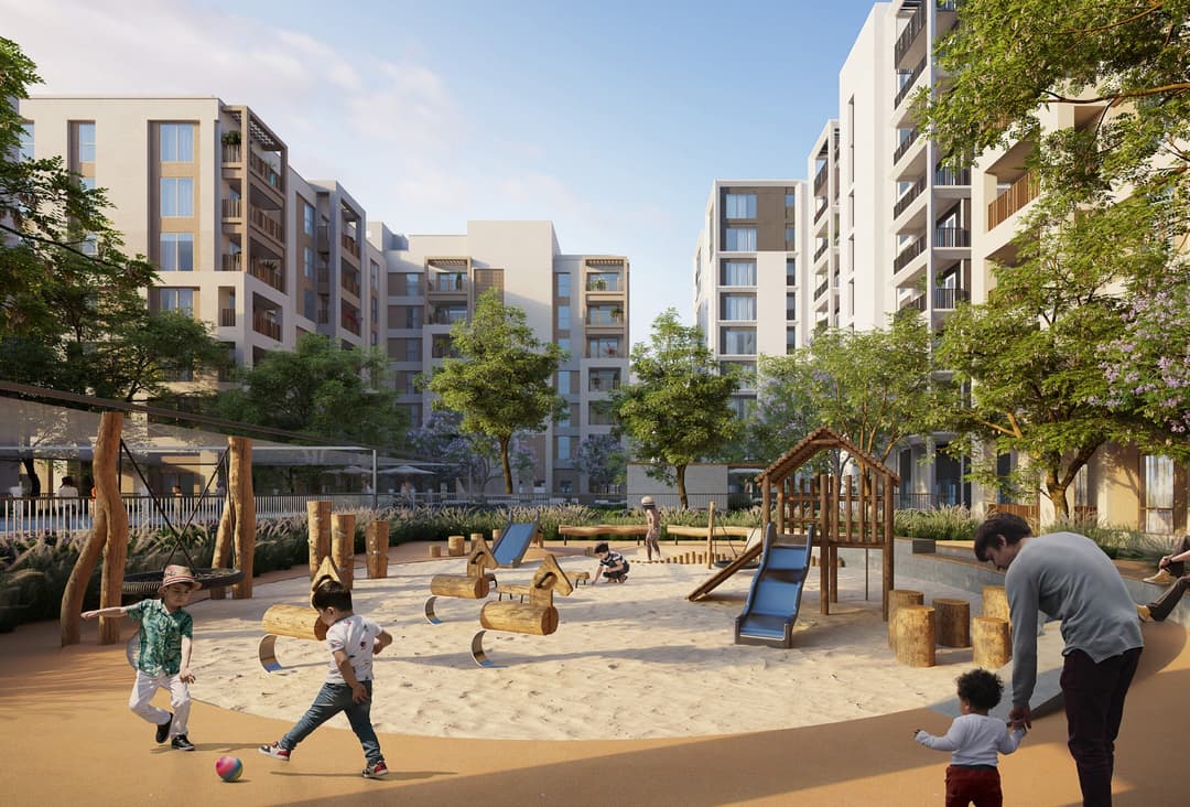 Playground in residential area. Children playing on swings, slides, and sand