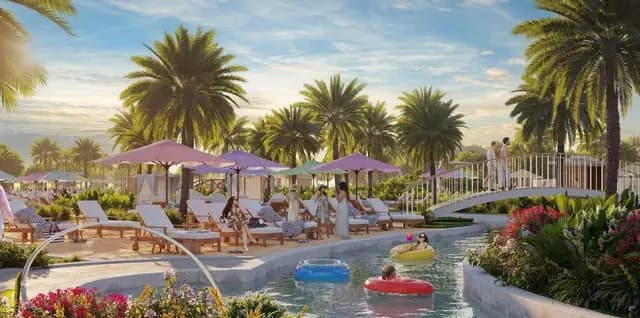Resort-style pool with palm trees, loungers, and bridge