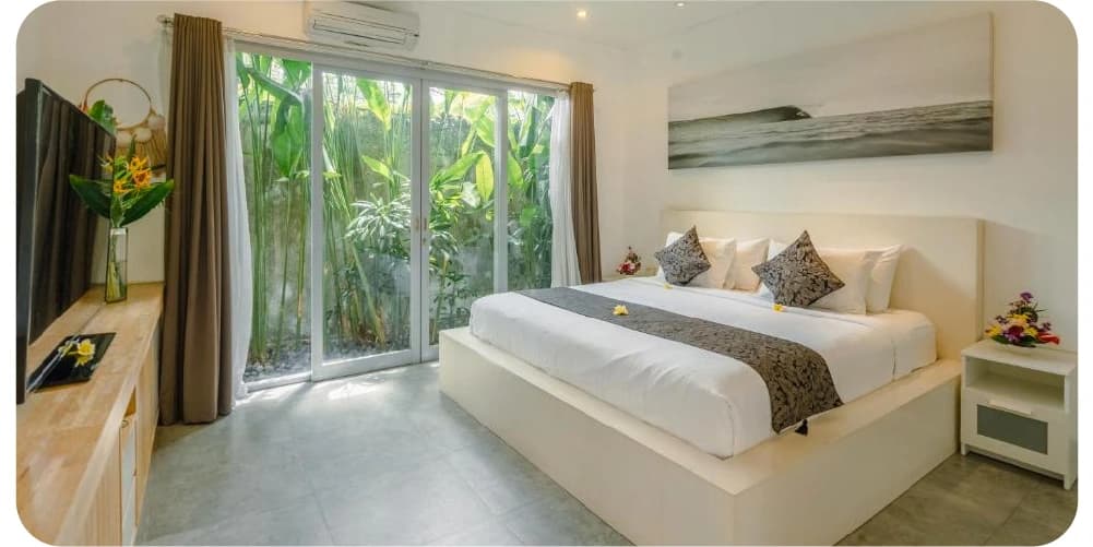 Cozy bedroom with natural light and tropical plants