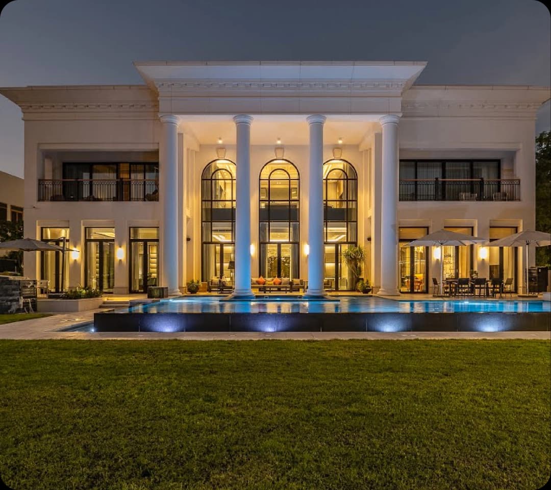 Elegant villa with a glowing pool at twilight