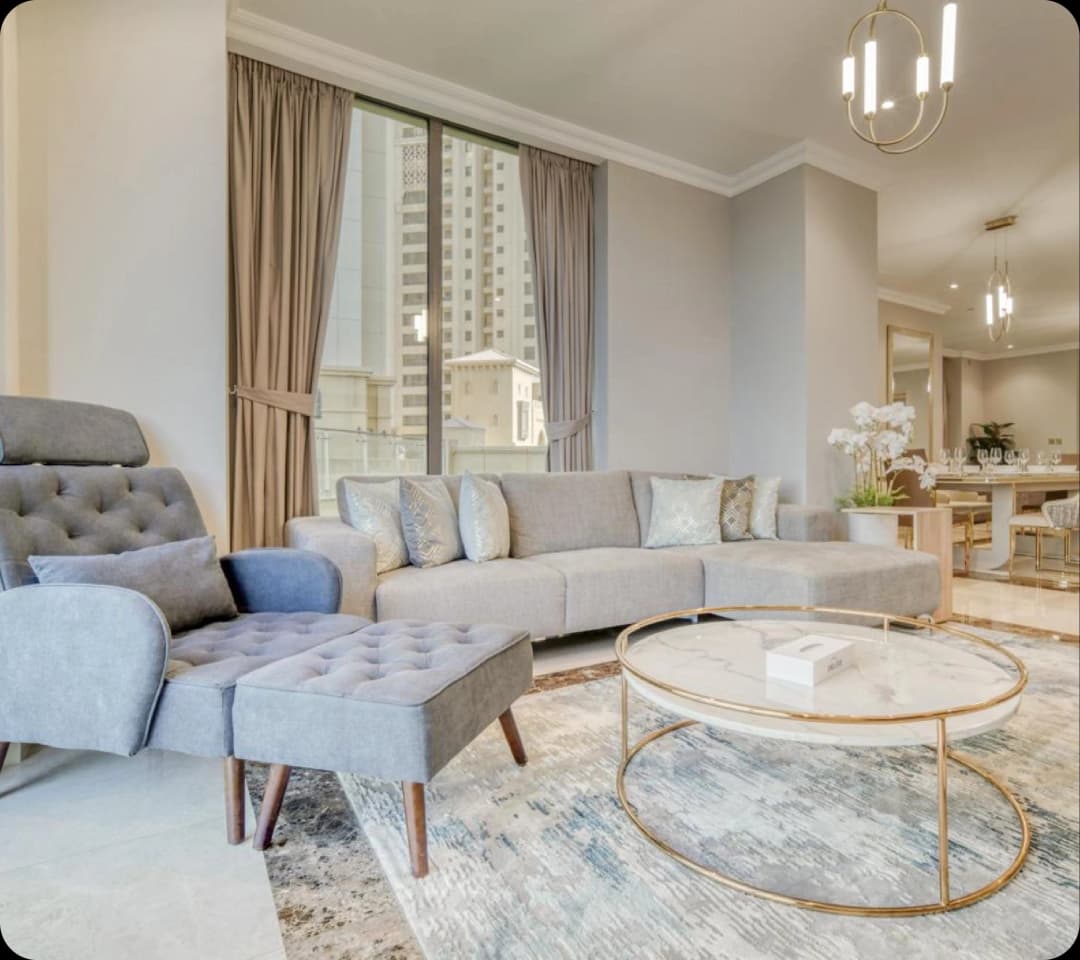 Neutral-toned living room with city view and modern furniture