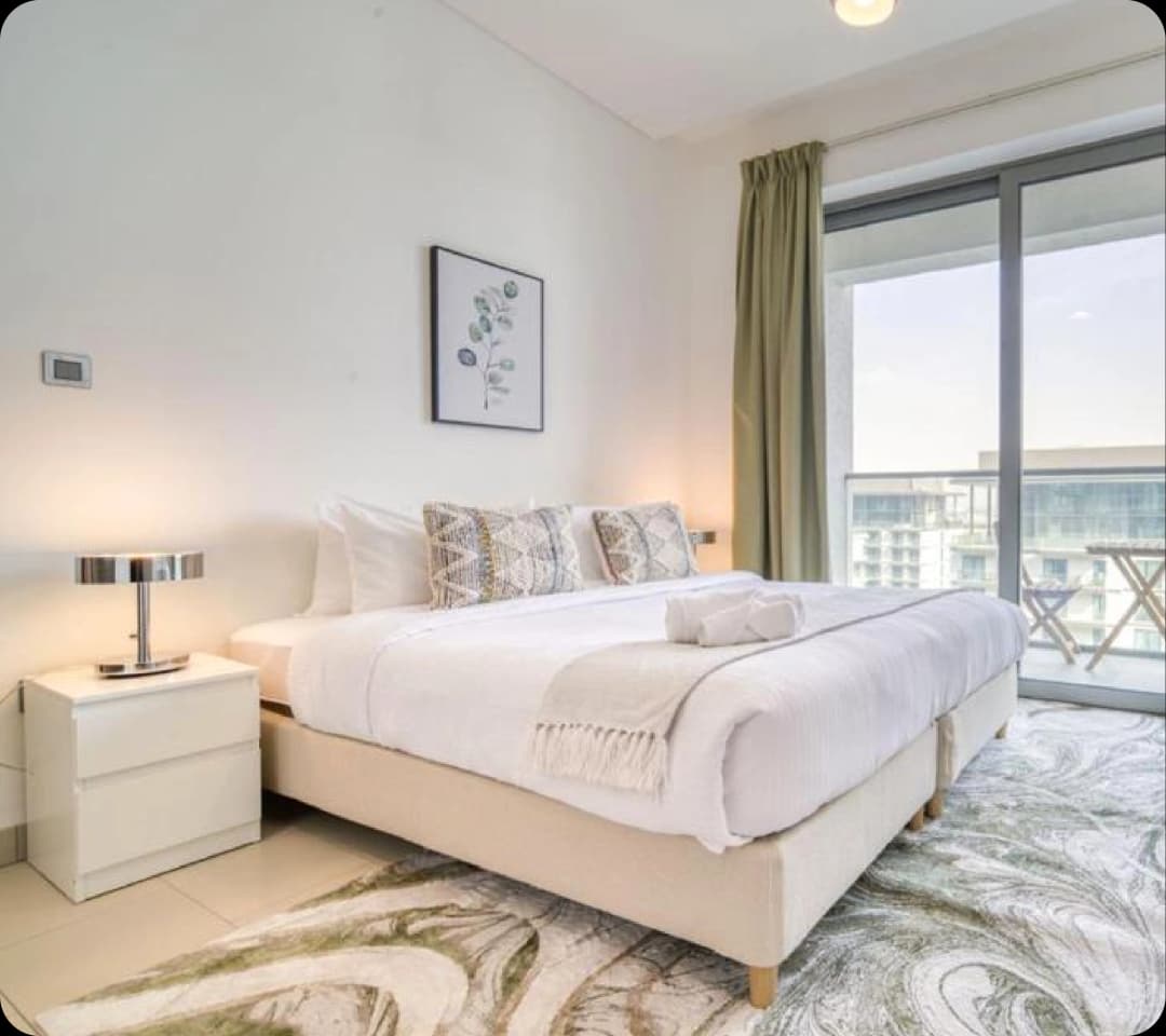 Modern bedroom with a balcony and city view