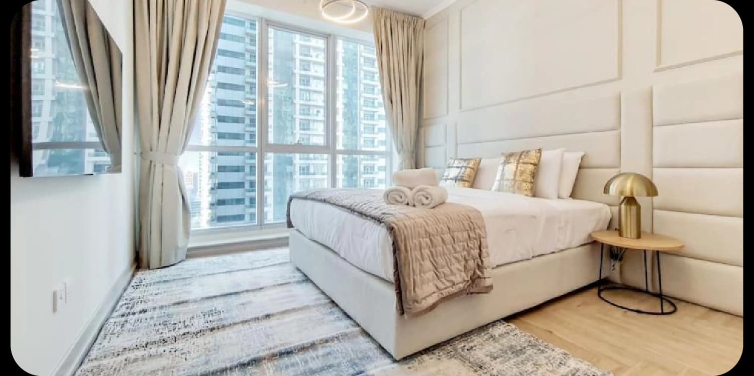 Modern bedroom with city view from large window