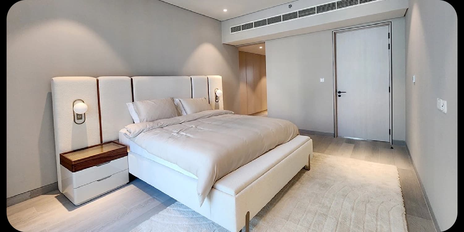 Modern bedroom with a large upholstered headboard