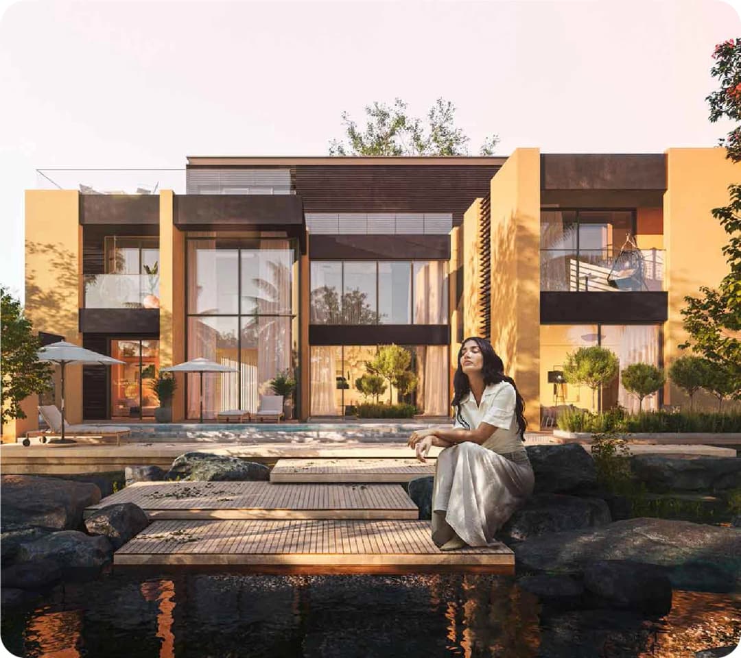 Modern luxury house with a woman sitting on rocks