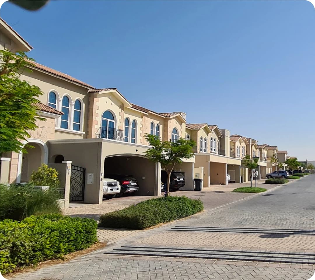 Row of villas with garages and trees along the street