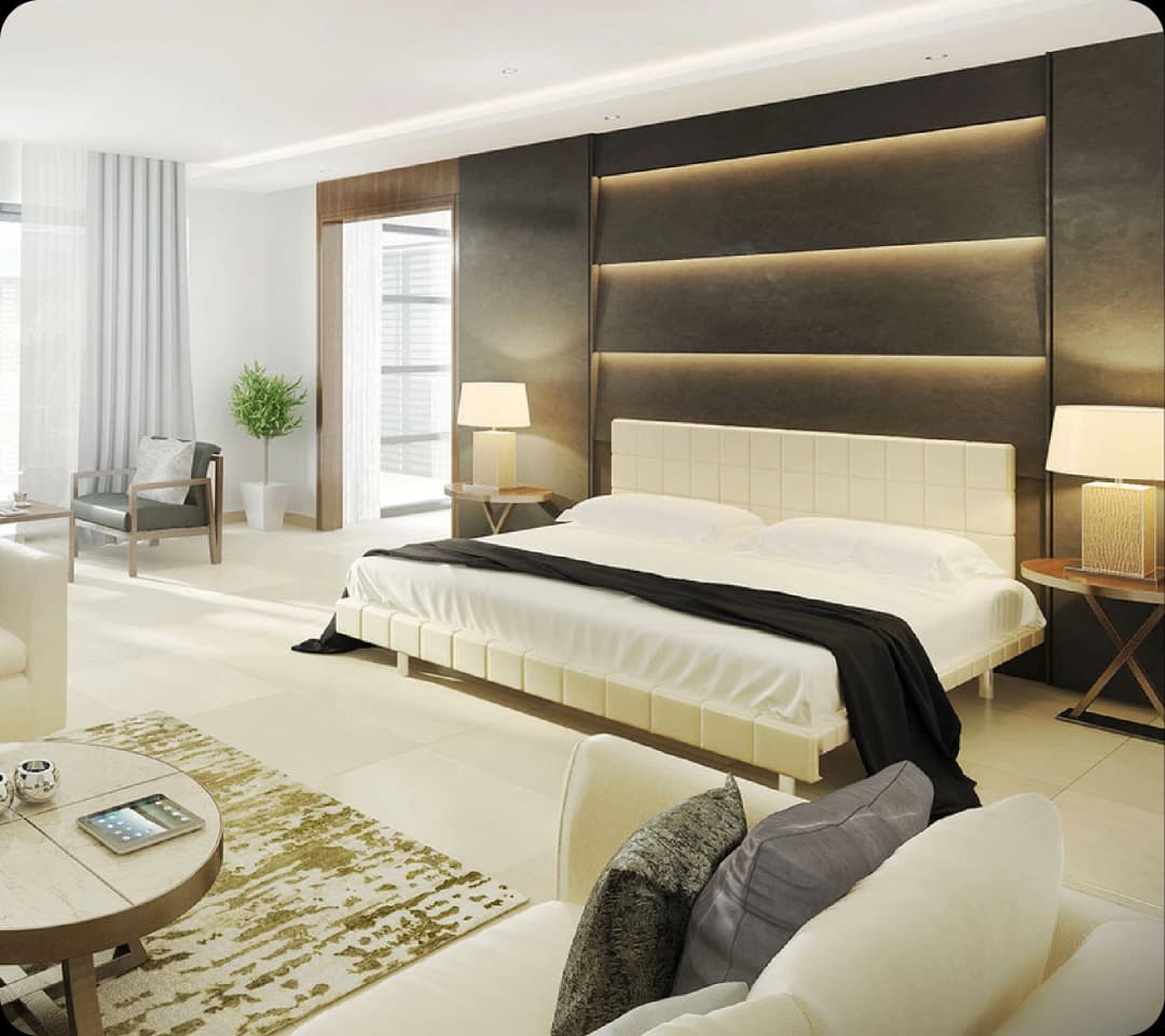Modern bedroom with a seating area and neutral tones