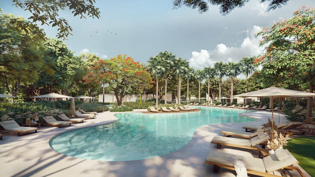 Serene resort-style swimming pool surrounded by lush greenery
