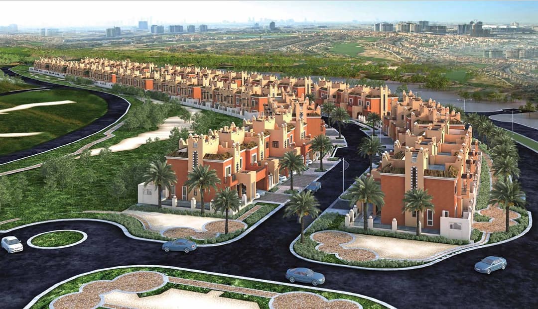 Aerial view of colorful villa community with landscaped surroundings