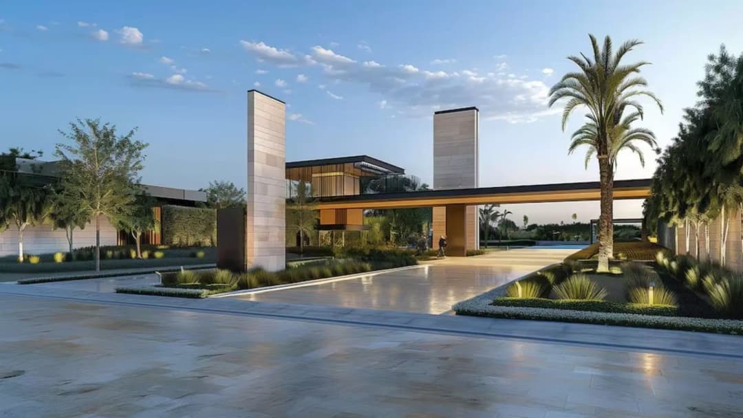 Modern entrance with tall pillars, palm trees, and pathway