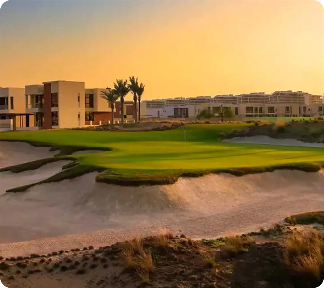 Sunset over golf course and modern buildings