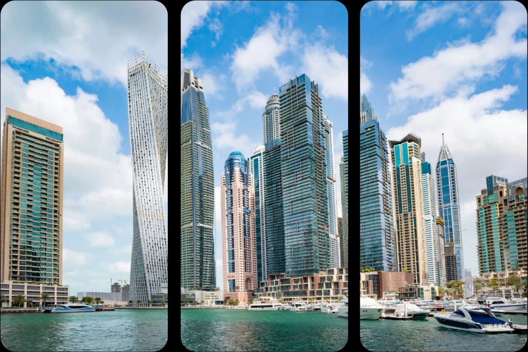 Dubai Marina skyline with yachts under a blue sky