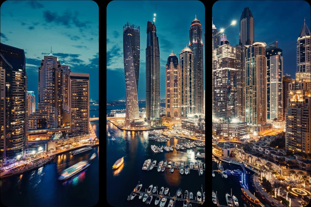 Night view of Dubai Marina with lit-up skyscrapers and boats