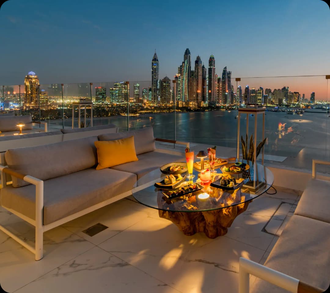 Rooftop dining area with stunning city views at dusk