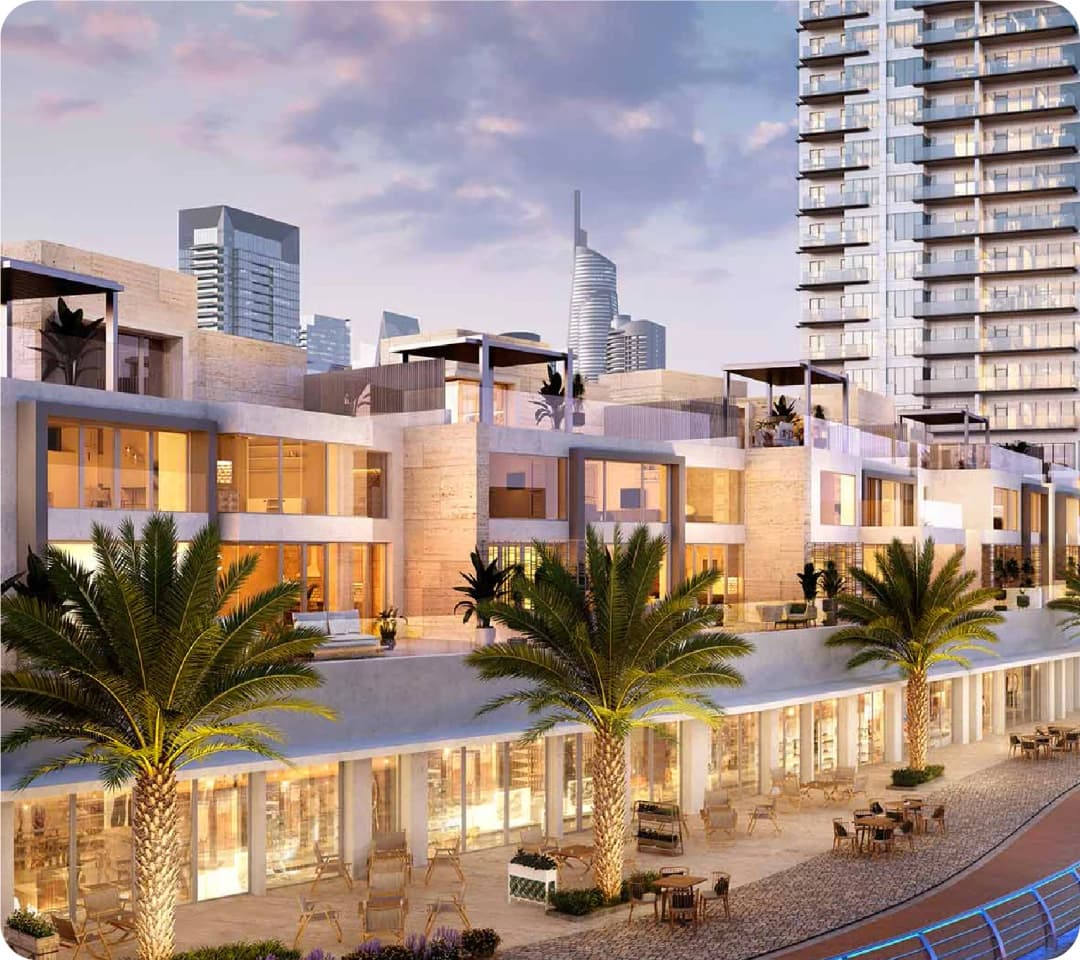 Modern residential complex with city skyline at sunset