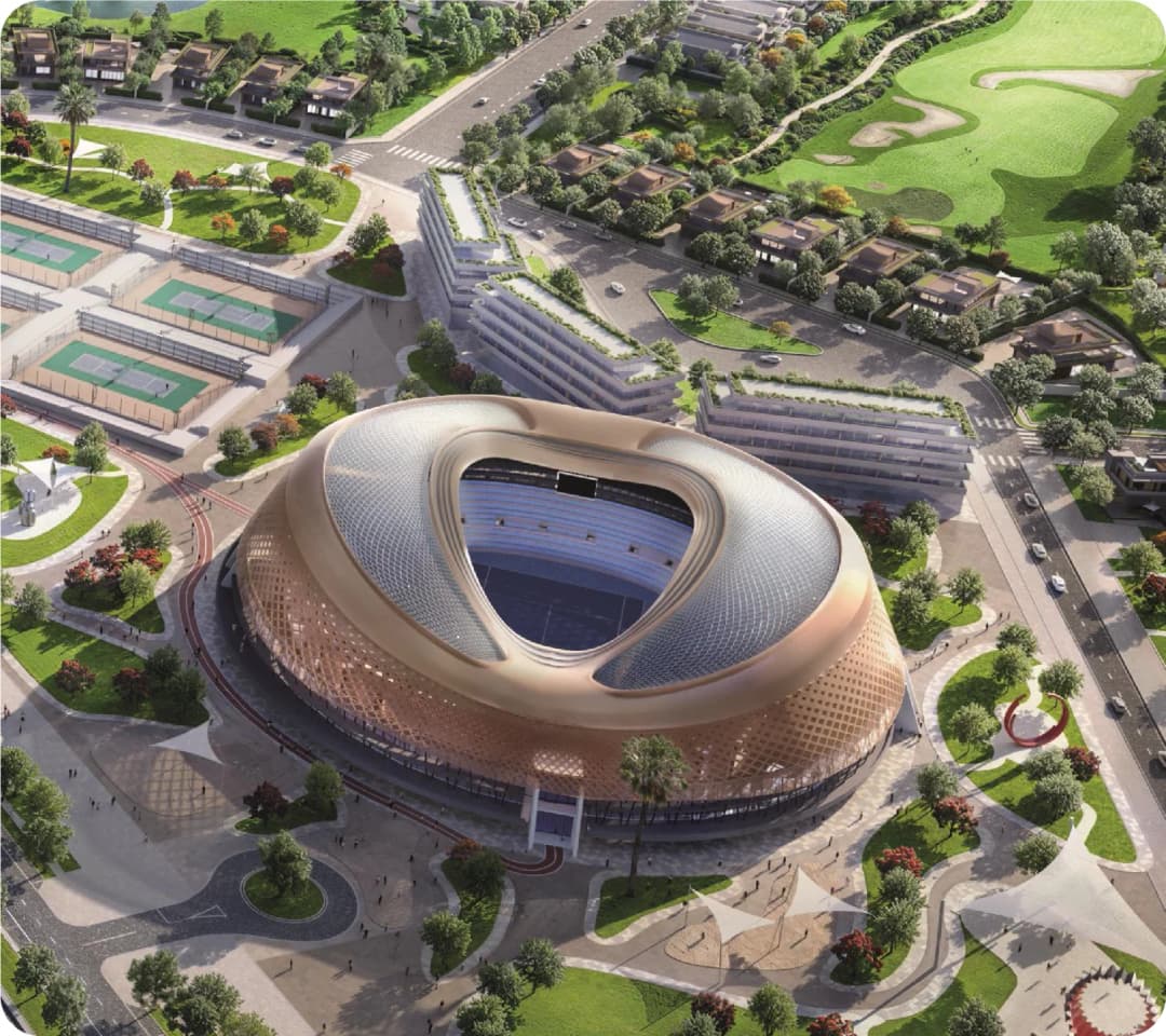 Aerial view of a modern stadium surrounded by tennis courts and lush greenery