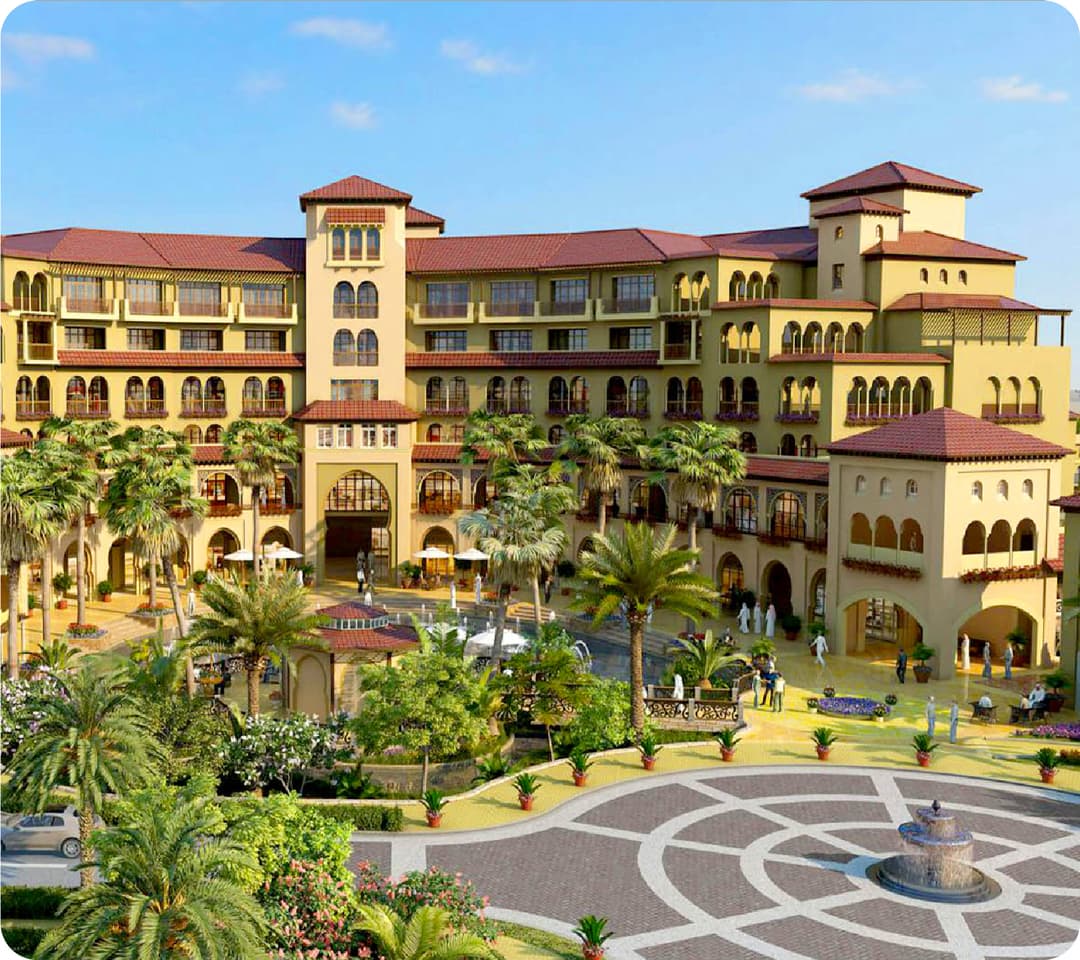 Elegant resort-style building with palm trees and a fountain
