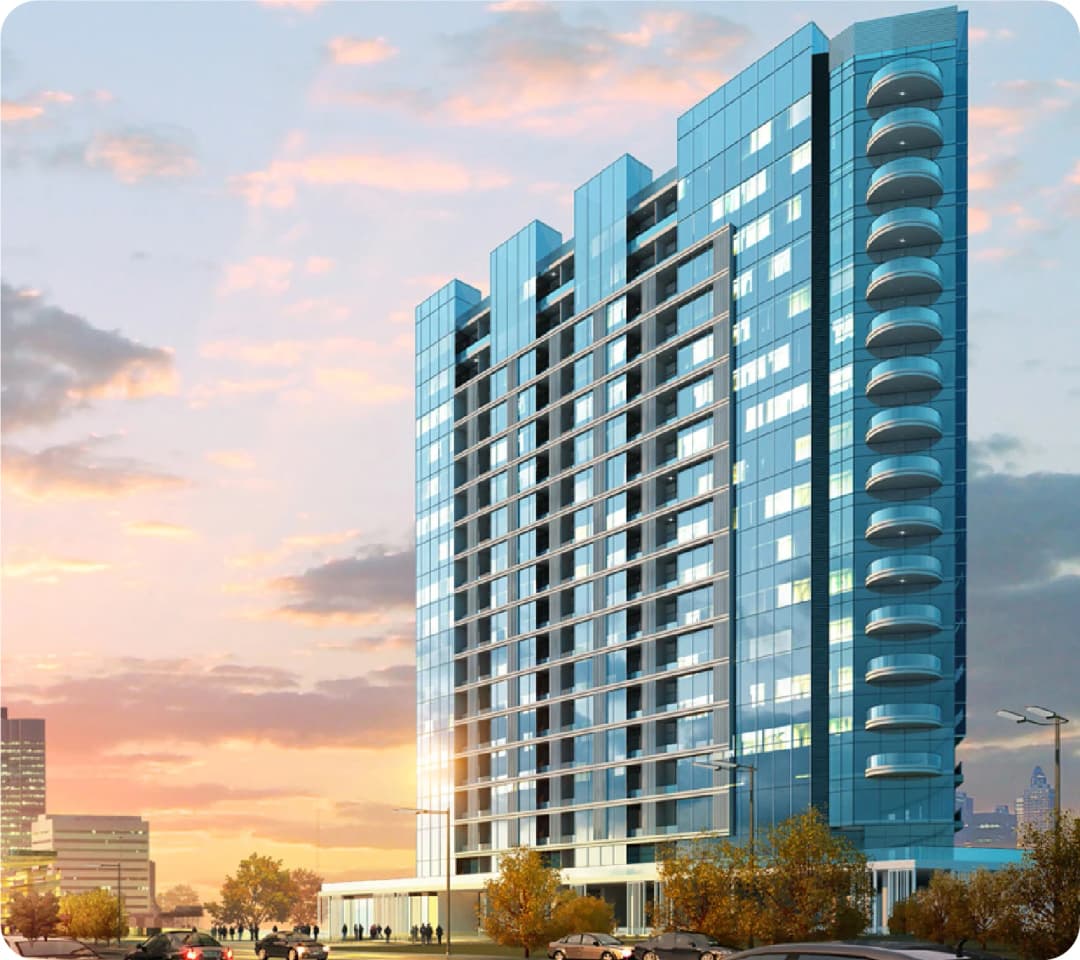 Modern glass tower building with balconies at sunset