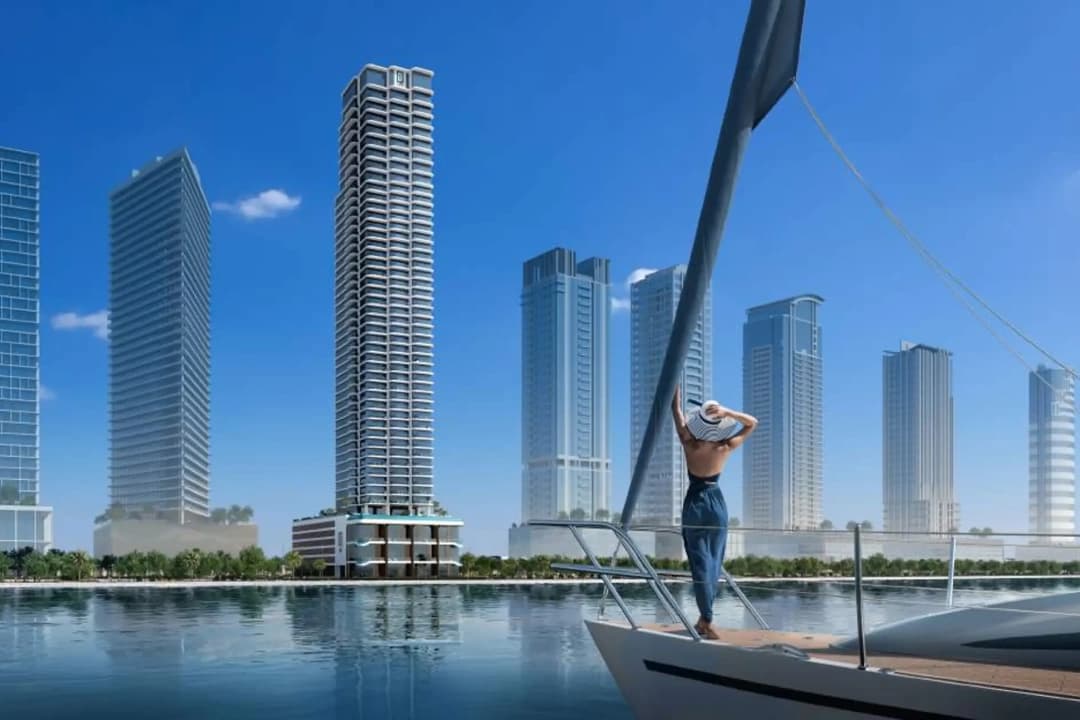 Woman on a yacht with skyscrapers and clear skies above