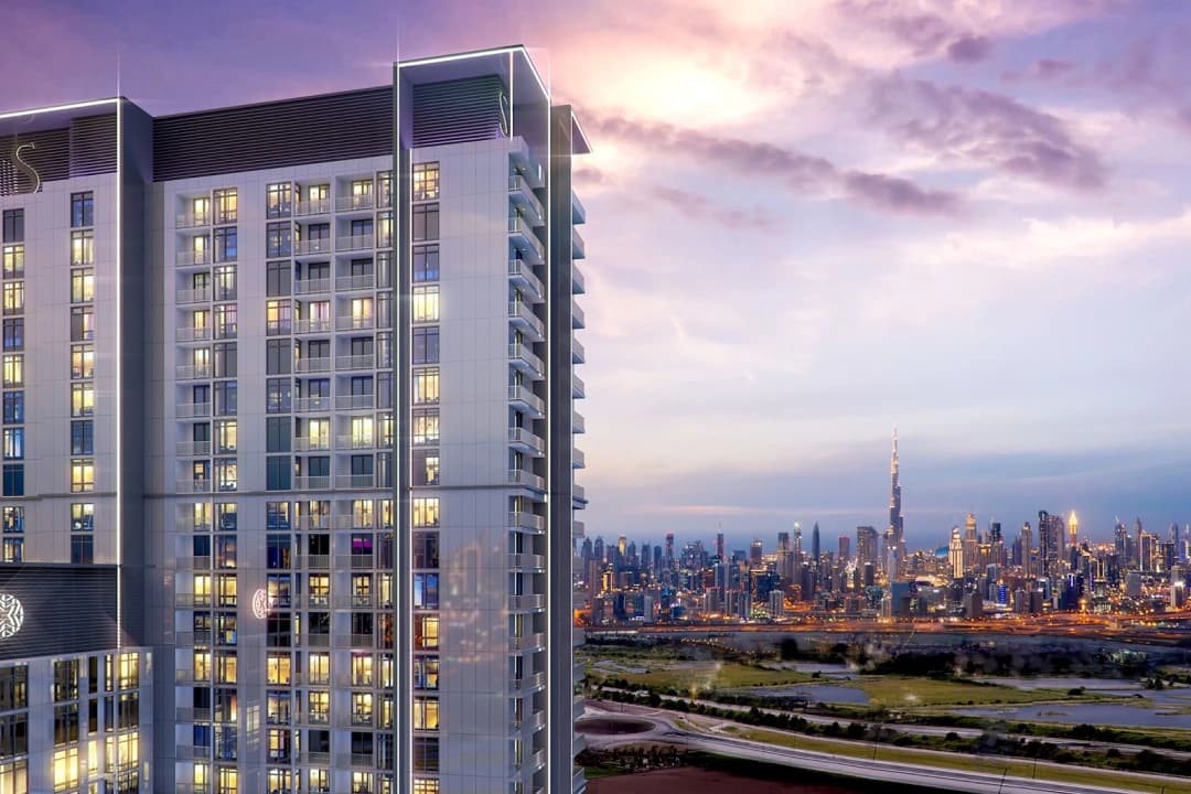 Evening view of a high-rise with Burj Khalifa lit up