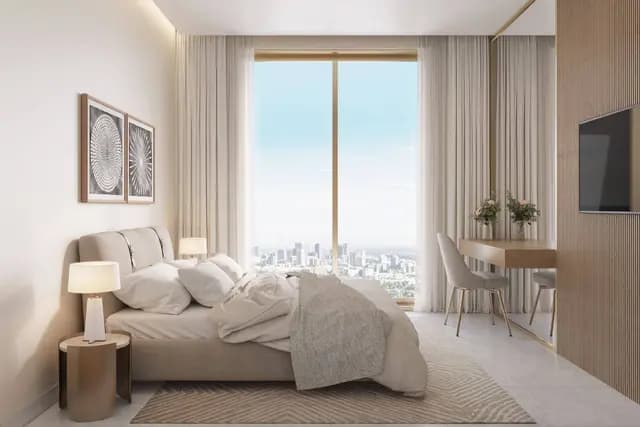 Cozy bedroom with large window and city view.