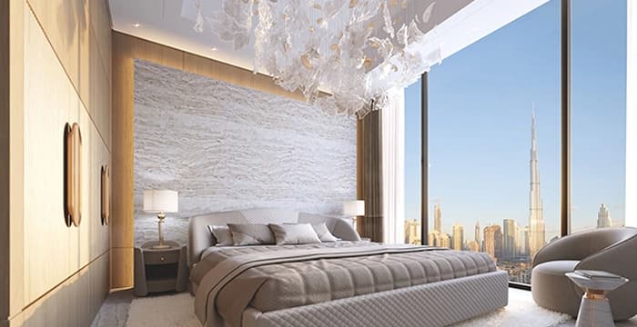 Stylish bedroom with black, gold accents, and chandelier