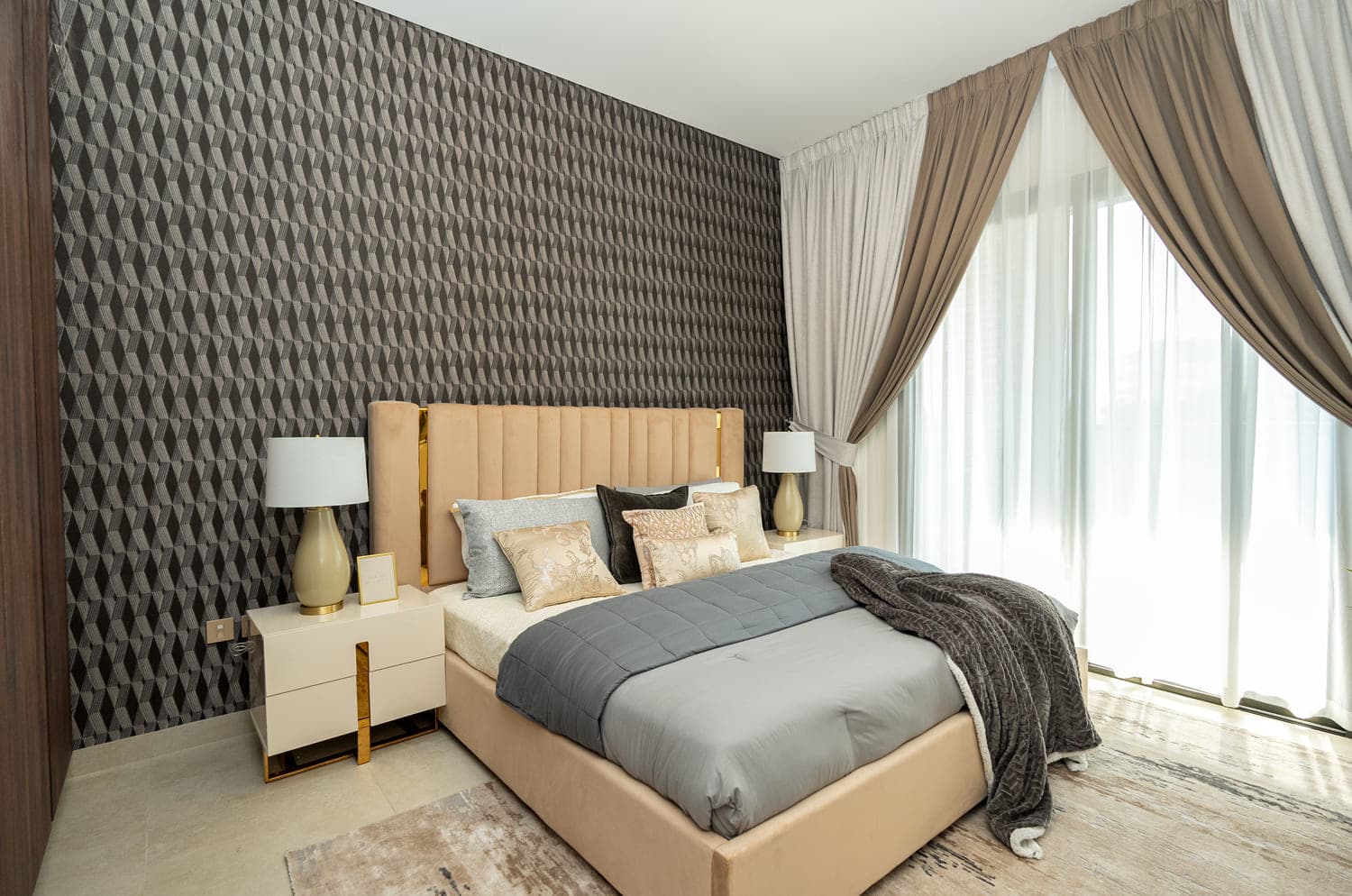 Elegant bedroom with geometric wallpaper and soft neutral tones