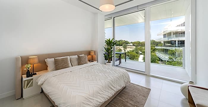 Modern bedroom with view of green landscape