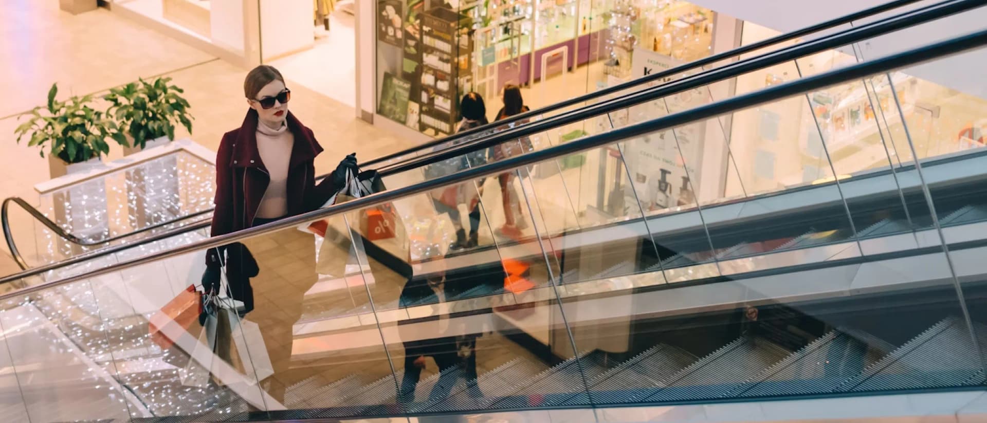 Shoppers on an escalator in a mall