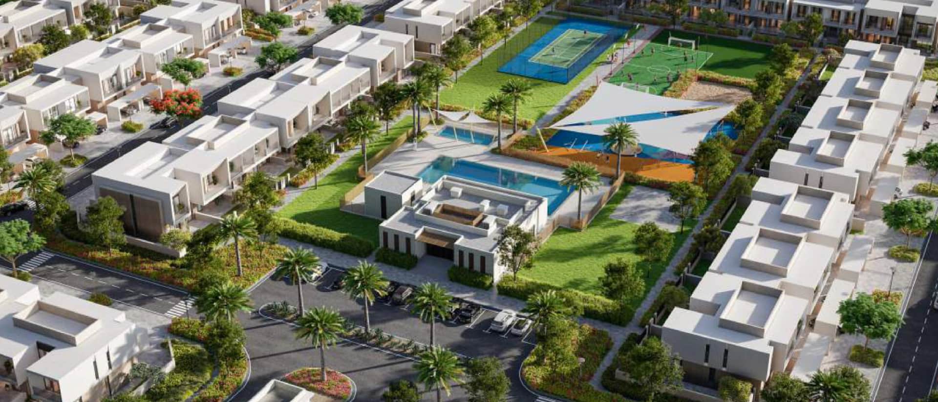 Aerial view of a community with modern townhouses, swimming pools, and sports courts