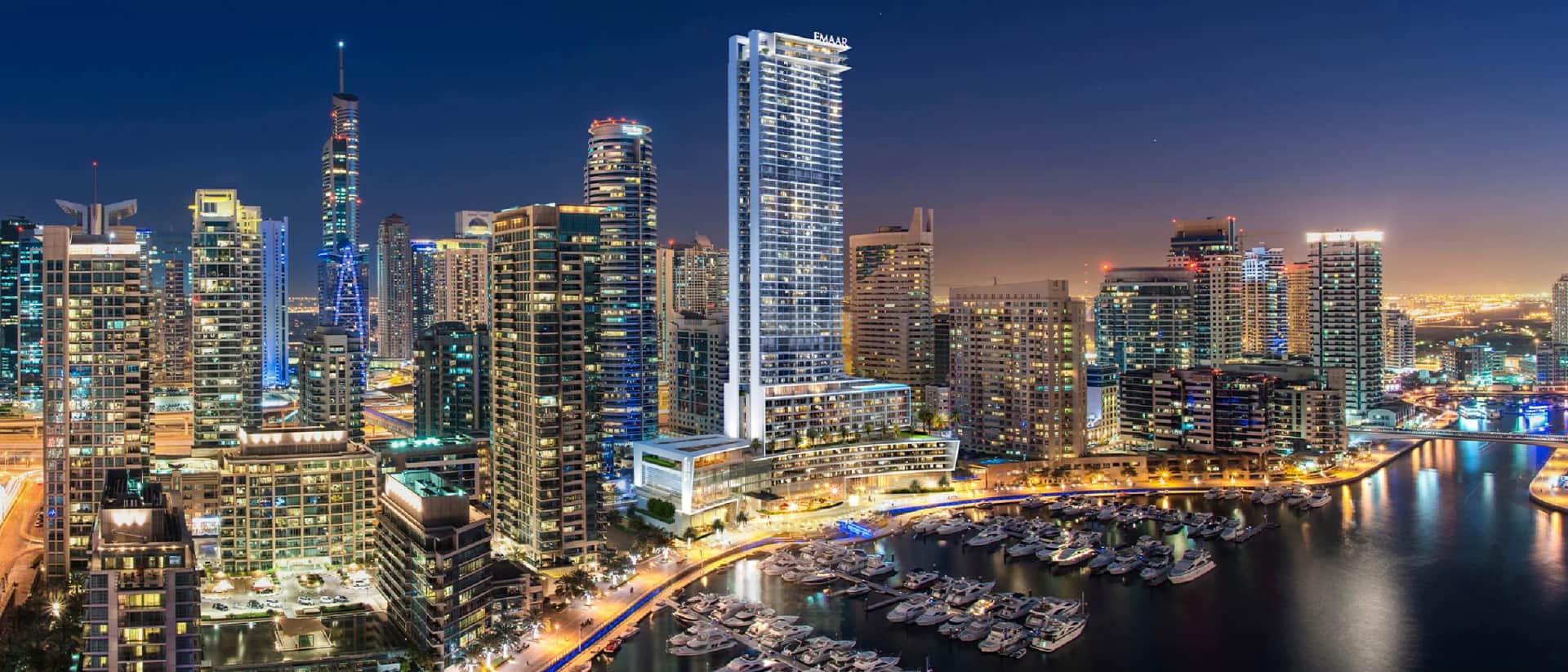 Dubai Marina skyline with Emaar tower and luxury yachts