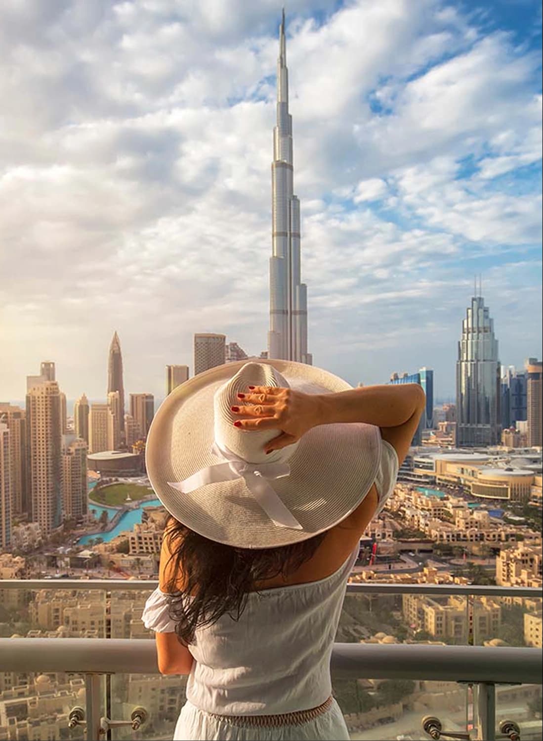 Woman enjoying the view of Burj Khalifa from a balcony
